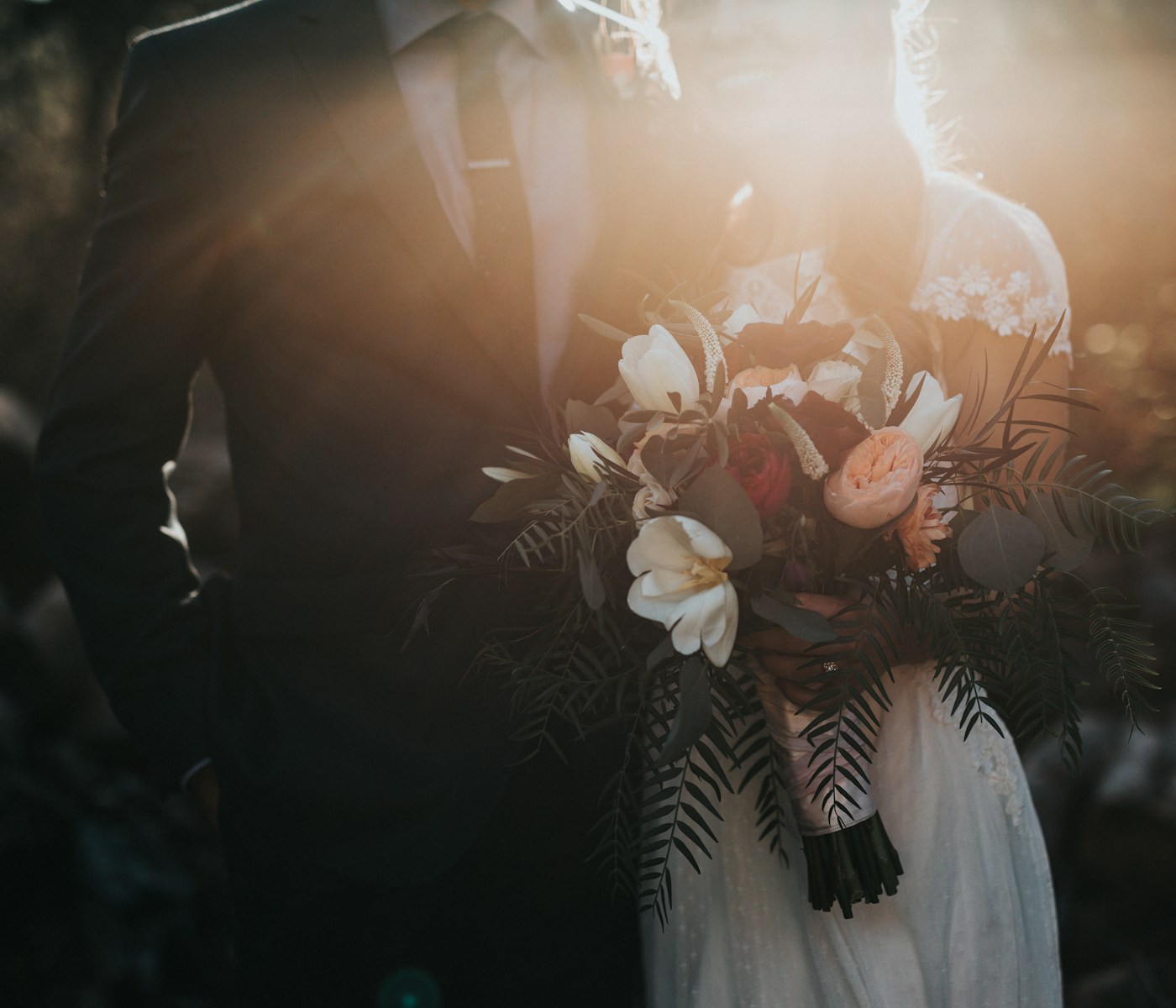 Couple de mariés tenant un bouquet
